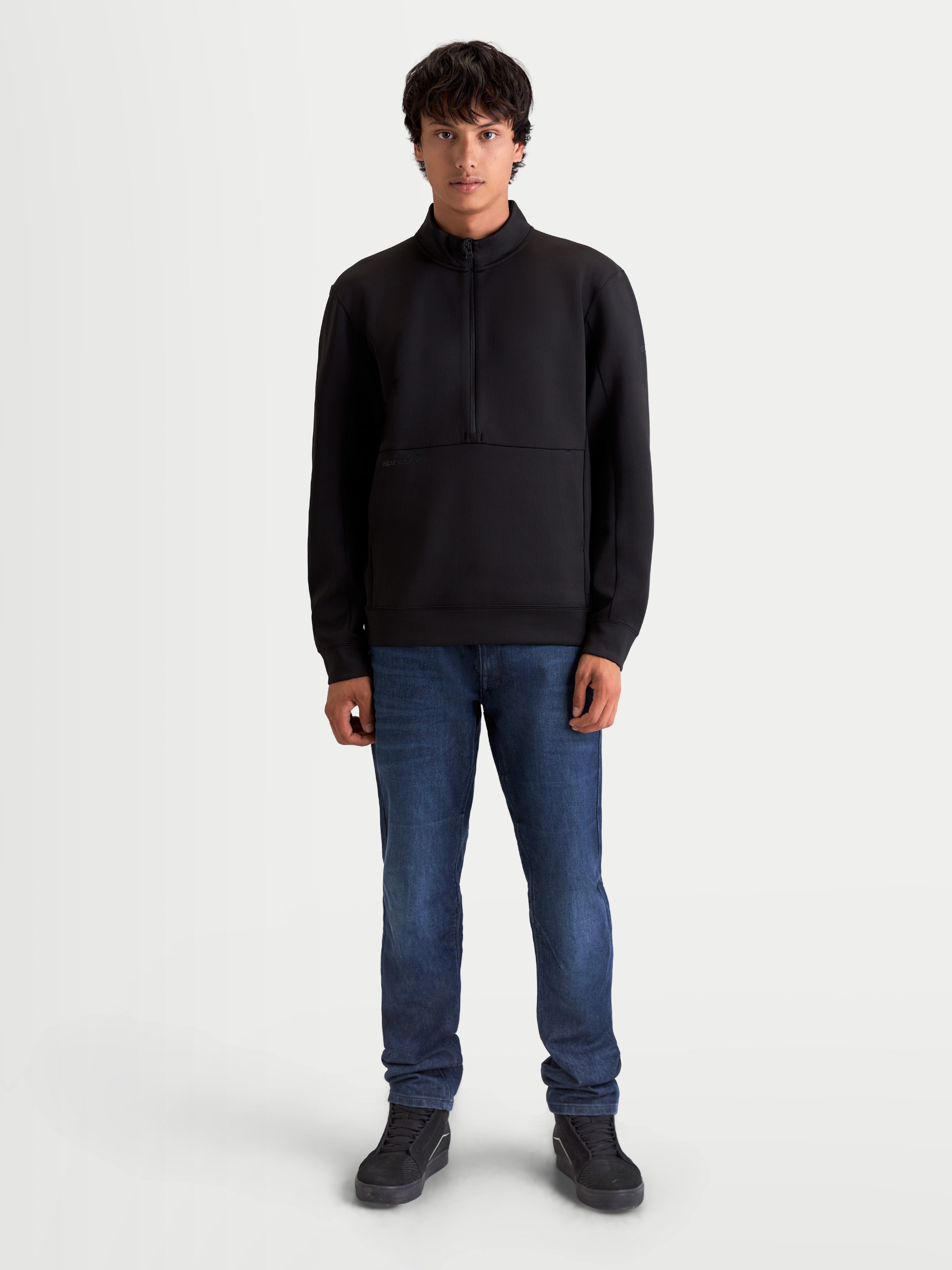 Alpinestars Apera Half-Zip Sweatshirt, Men's Sportswear Pullover in Black, featuring a half-zip closure and kangaroo pocket. Premium tri-blend fleece construction with motorsport-inspired styling and tonal Alpinestars branding for casual everyday comfort.
