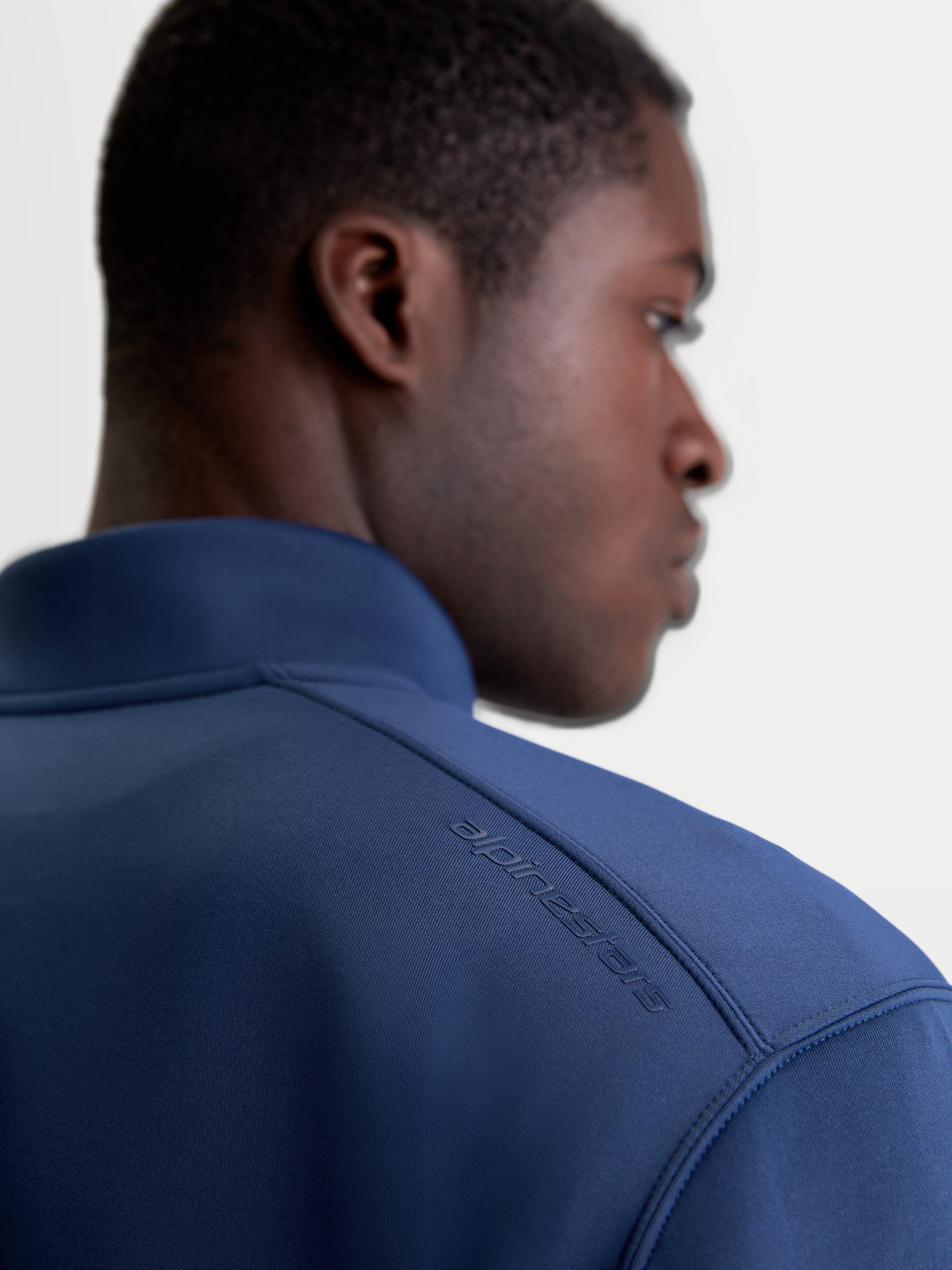 Alpinestars Apera Half-Zip Sweatshirt, Sportswear Pullover in Steel Blue, close-up back view on model showing the tonal HD Alpinestars logo print on the shoulder and premium tri-blend fleece fabric.
