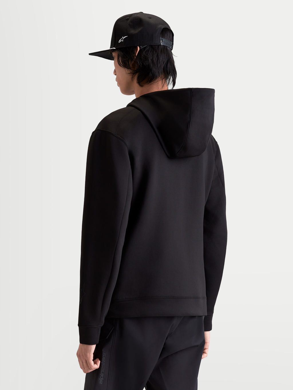 Alpinestars Datrix Hoodie, Men's Sportswear Pullover in Black, Rear View on Model showing the double-face fleece construction and mesh-lined hood for casual comfort and motorsport-inspired style.