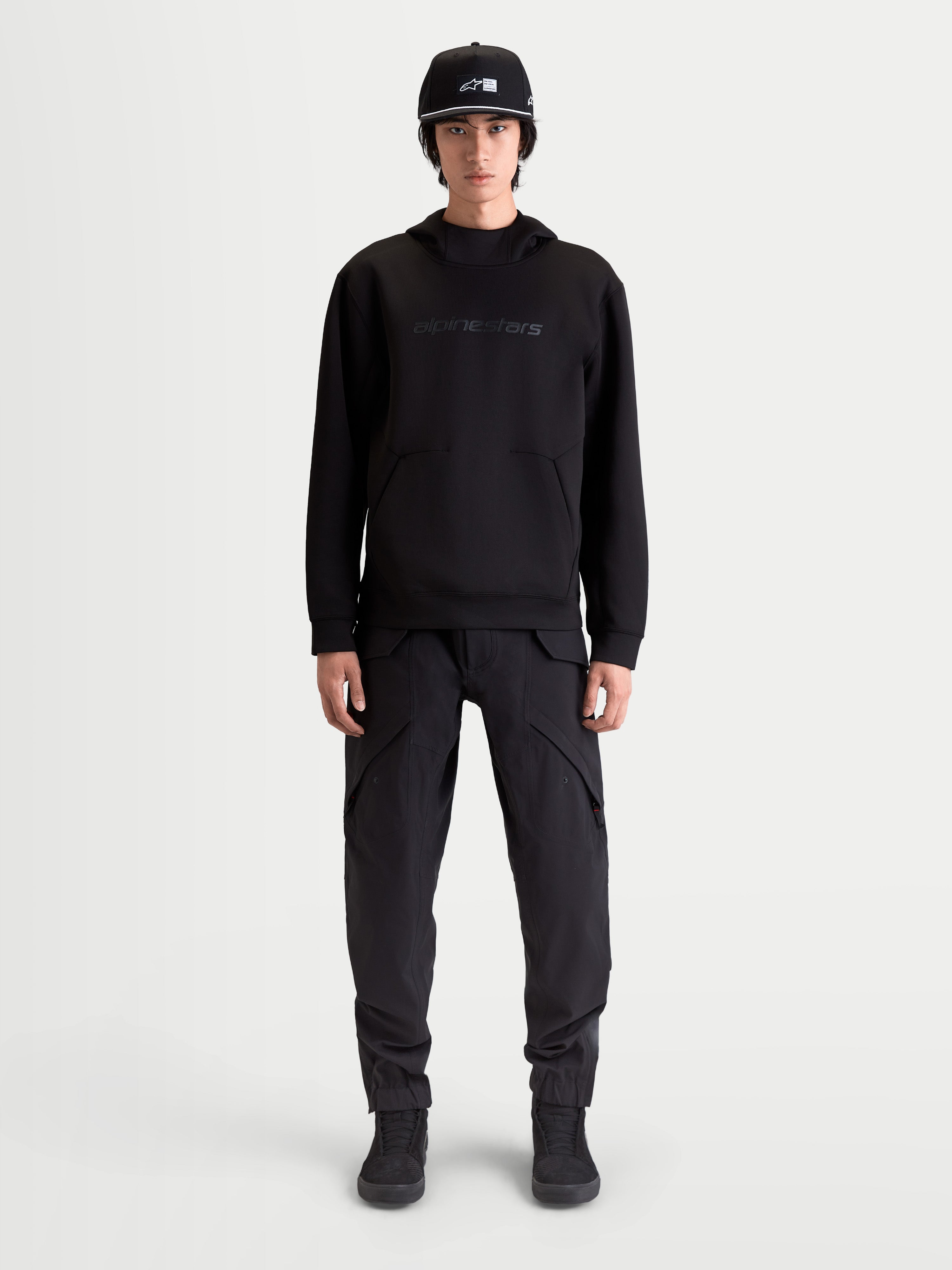 Alpinestars Datrix Hoodie, Men's Premium Sportswear Pullover, Black, featuring tonal HD Alpinestars branding, tri-blend double-face fleece, and dart-detail pocket, shown on model for everyday motorsport-inspired style.