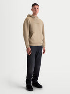 Alpinestars Datrix Hoodie, Men's Sportswear Pullover in Putty Tan, featuring tonal HD branding, a mesh-lined hood, and a dart-detail front pocket, shown on model for a casual motorsport-inspired look.