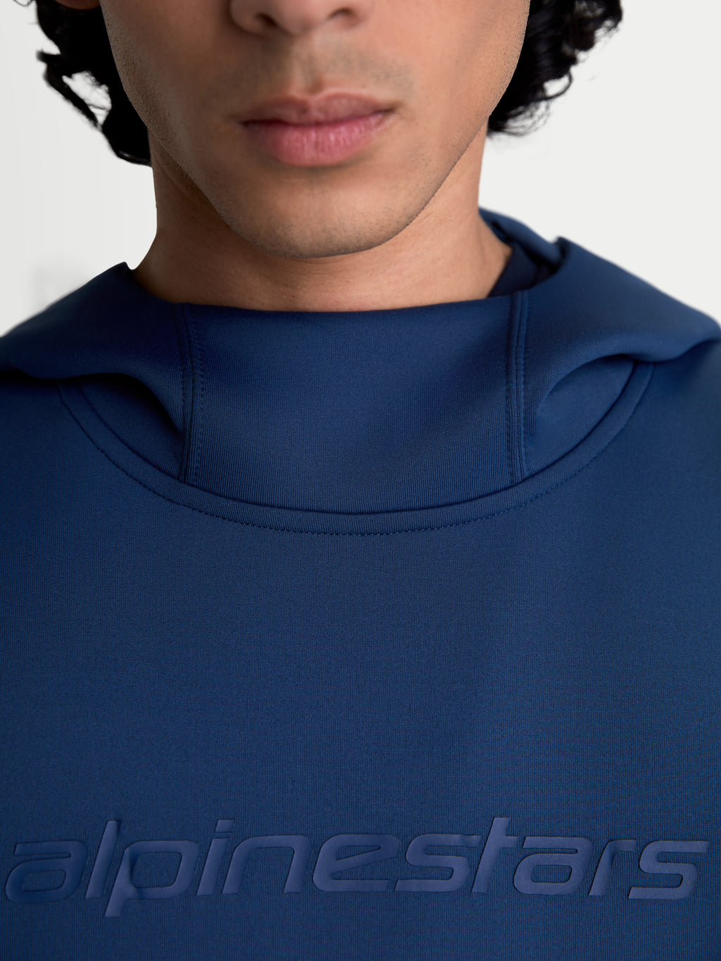 Alpinestars Datrix Hoodie, Men's and Women's Sportswear Pullover, Steel Blue, featuring a close-up of the tonal HD Alpinestars branding on the chest and the mesh-lined hood neck construction, premium tri-blend double-face fleece.
