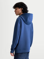 Alpinestars Datrix Hoodie, Sportswear Pullover Hoodie for casual motorsport-inspired style, Steel Blue, double-face fleece construction with a mesh-lined hood, back and side profile view on a model.
