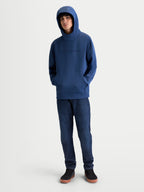 Alpinestars Datrix Hoodie, Motorsport-Inspired Sportswear Pullover, Steel Blue, Premium Tri-blend Fleece, featuring a tonal HD logo on the chest and a mesh-lined hood worn up by a model.