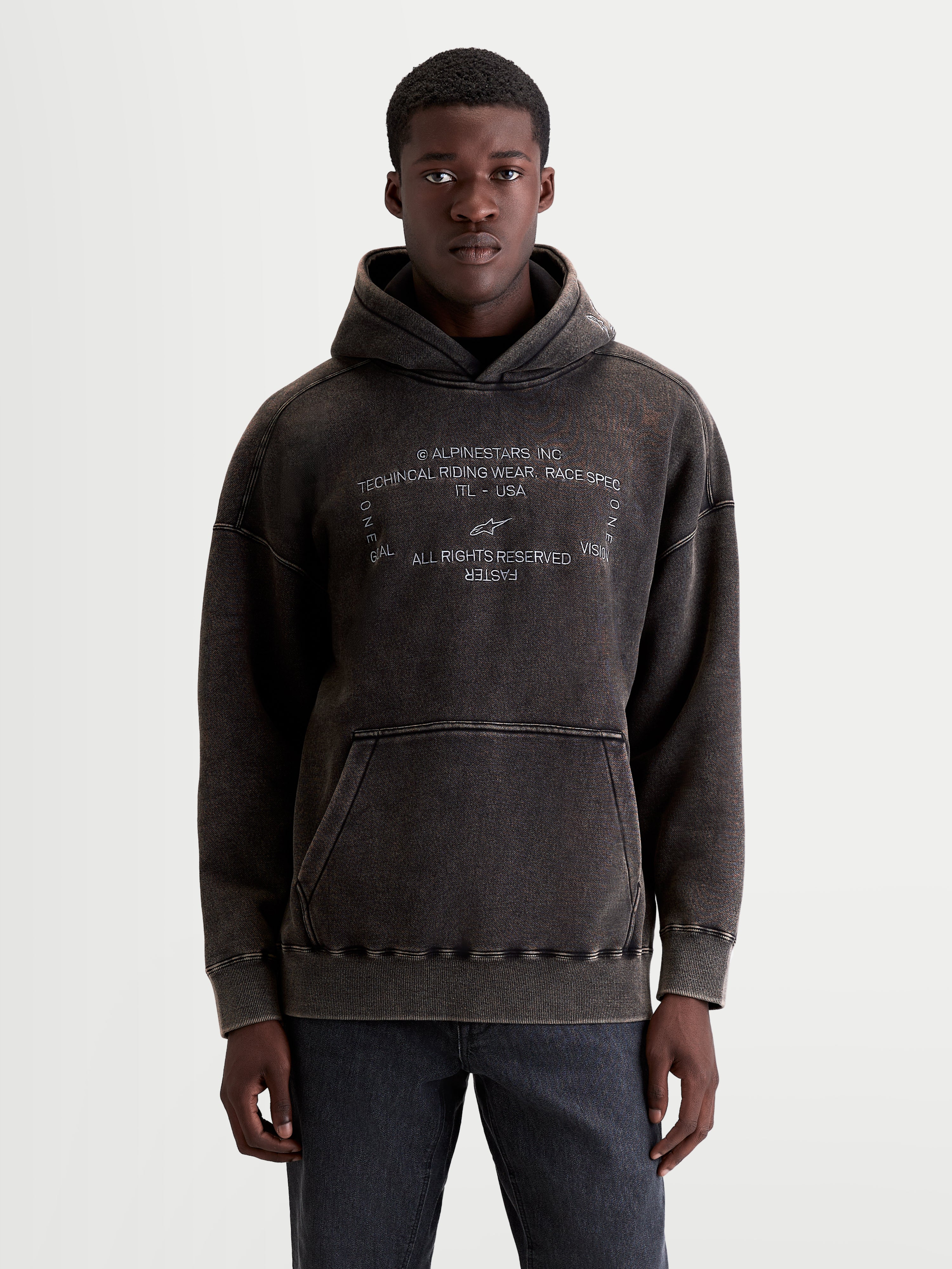 Alpinestars Infinite Washed Oversized Hoodie, Sportswear Pullover for Men and Women, Washed Black, Cotton and Recycled Polyester Fleece, featuring a snow-wash finish, embroidered chest graphic, and kangaroo pocket.