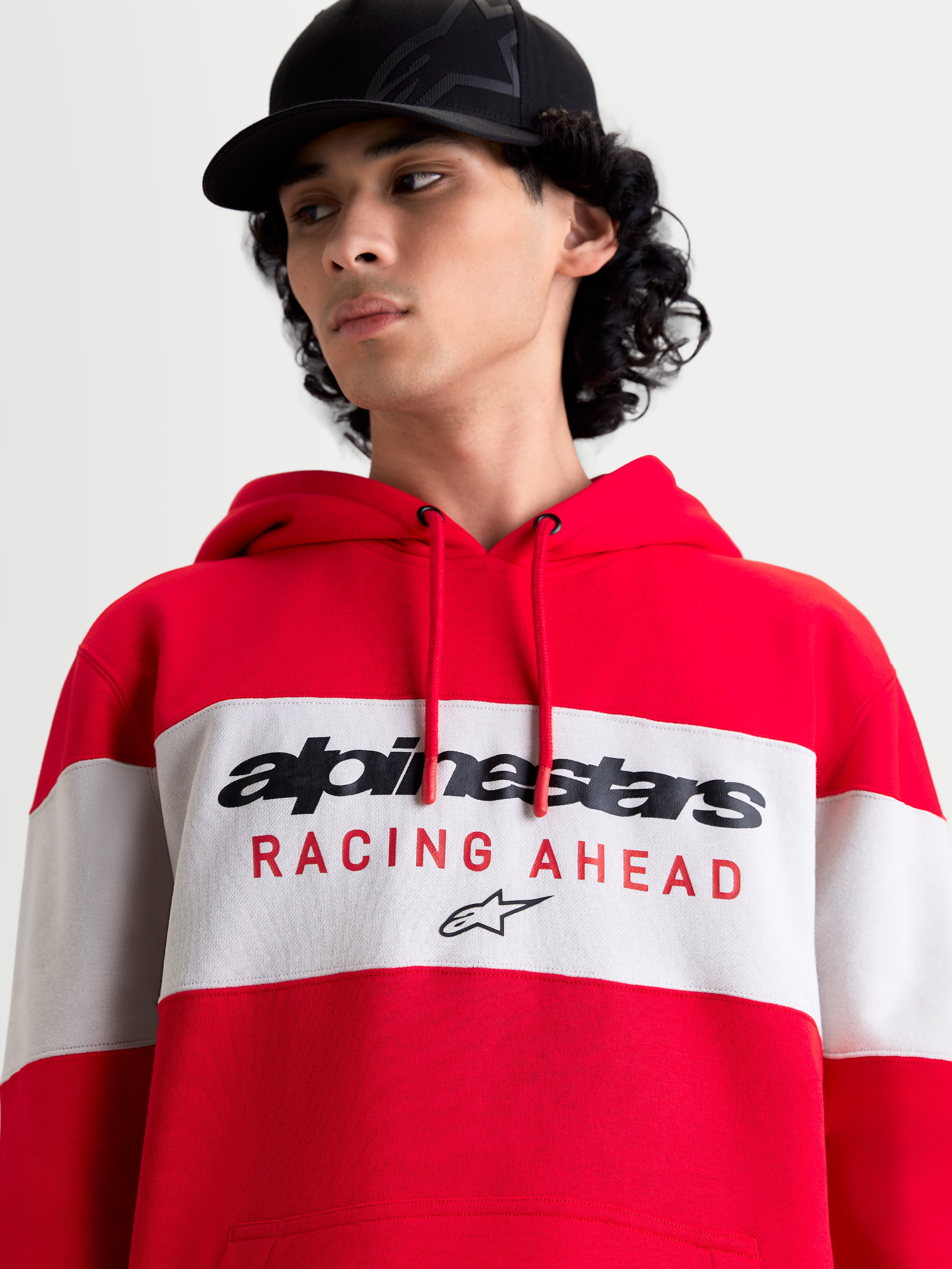 Alpinestars Cubic Hoodie, Men's and Women's Casual Sportswear Pullover Fleece, Red and Cement, featuring a color-blocked design with the Alpinestars word logo and Racing Ahead graphic on the chest, on-model lifestyle view.