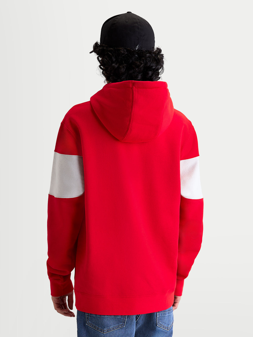 Alpinestars Cubic Hoodie, Sportswear Pullover Fleece, Red and White, Back View on Model wearing a black cap, featuring color-blocked sleeves, a self-lined hood, and ribbed cuffs for a motorsport-inspired look.