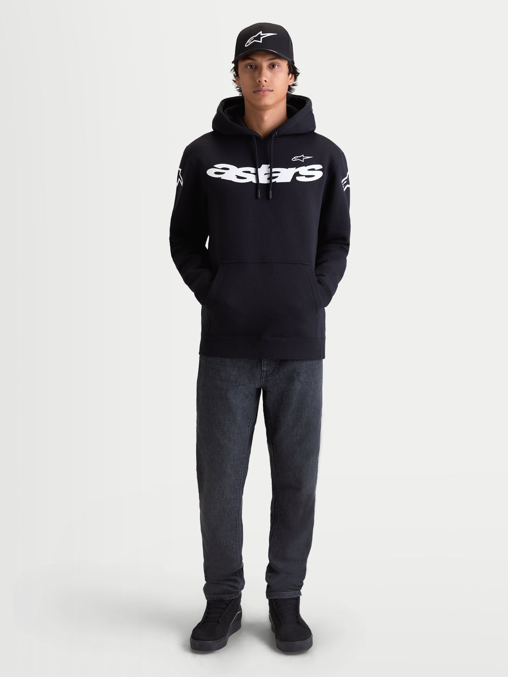 Alpinestars Velocifier Hoodie, Men's Black Pullover Fleece, Sportswear for Casual Off-Bike Wear, features White Astars wordmark on front and shoulder logos, premium cotton blend, shown on model with matching cap.