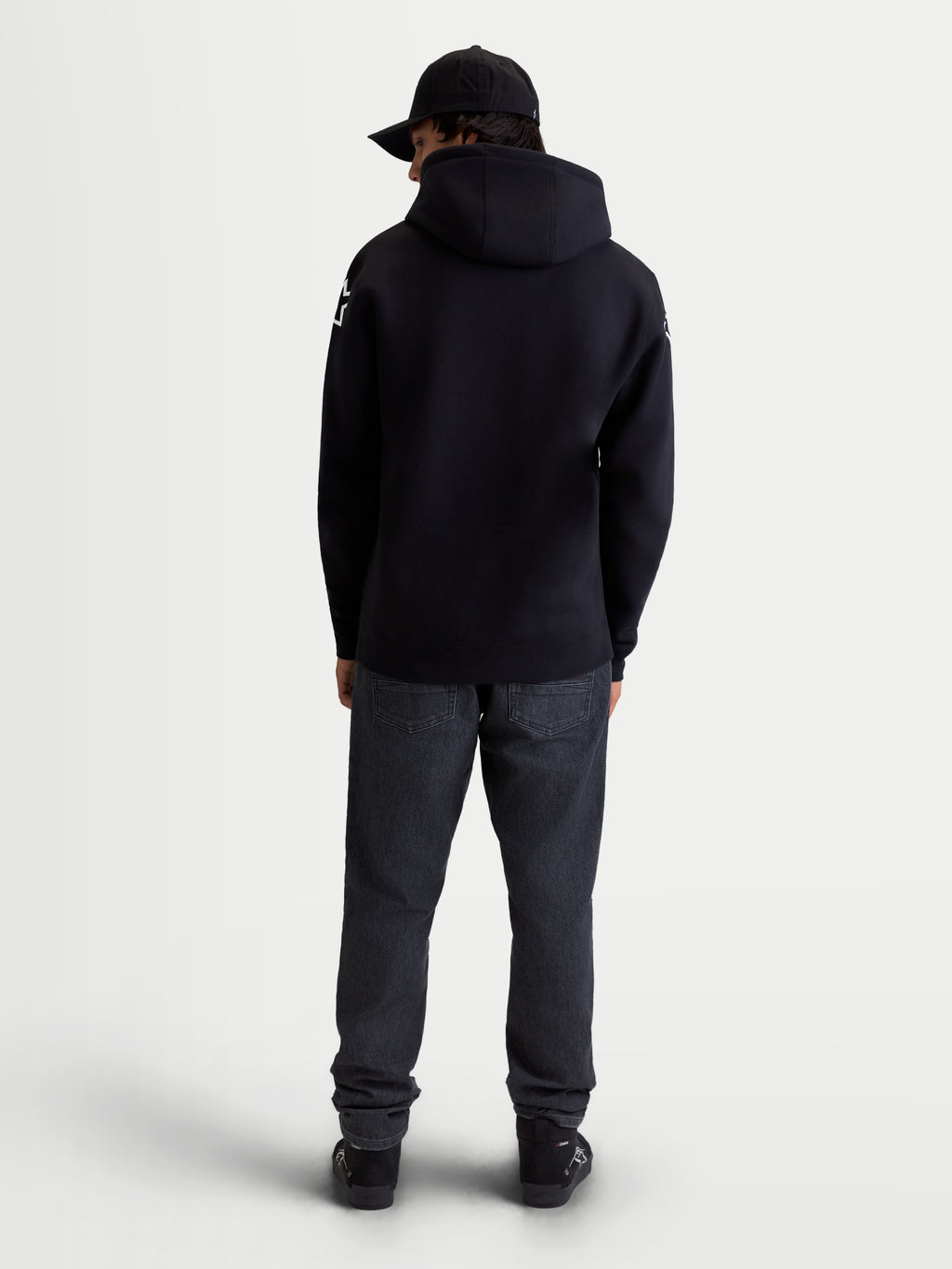 Alpinestars Velocifier Hoodie, Men's Sportswear Pullover Fleece, Black, cotton and recycled polyester blend, rear view on model showing hood and white Alpinestars logos on shoulders.