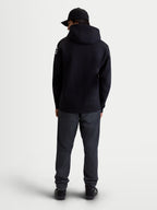 Alpinestars Velocifier Hoodie, Men's Sportswear Pullover Fleece, Black, cotton and recycled polyester blend, rear view on model showing hood and white Alpinestars logos on shoulders.
