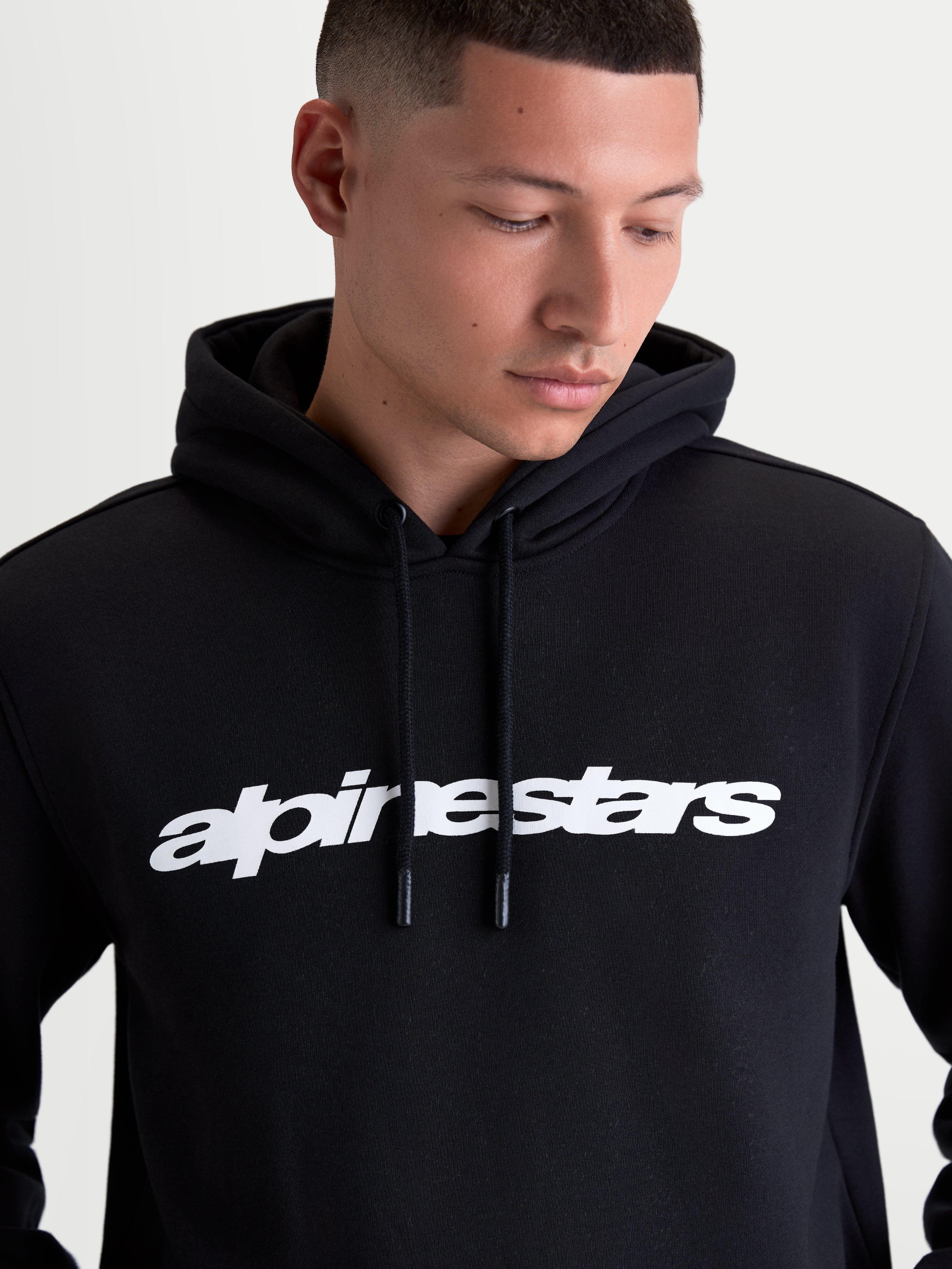 Alpinestars Race Wordmark Hoodie, Men's Casual Sportswear Pullover Fleece, Black and White, featuring a bold front linear logo, self-lined hood with dipped drawcord tips, constructed from a comfortable cotton and recycled polyester blend.