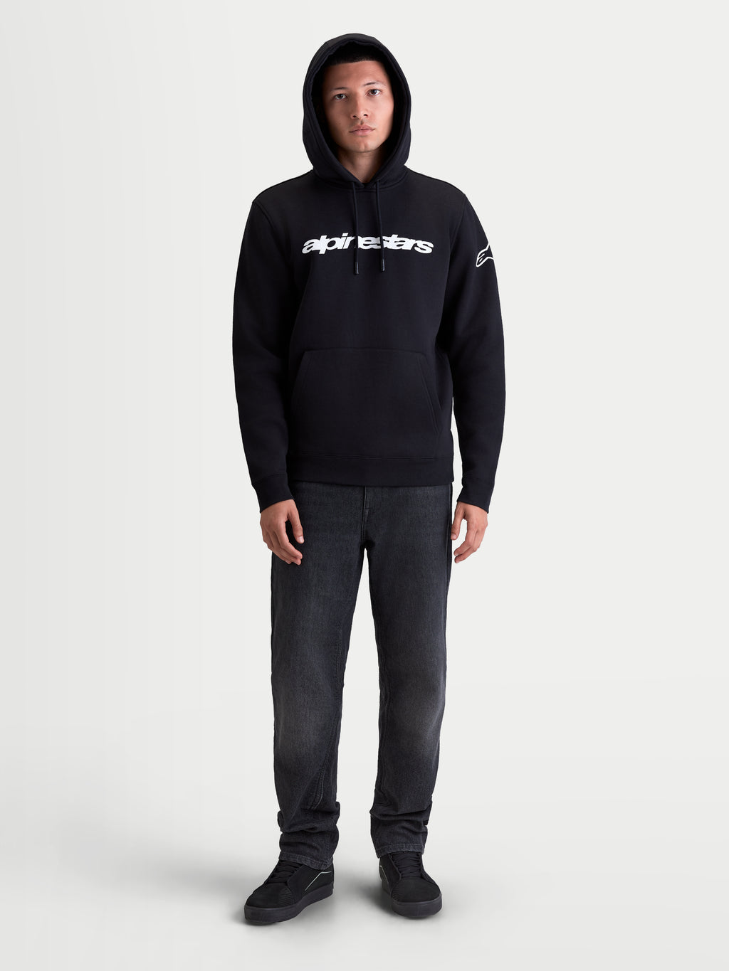 Alpinestars Race Wordmark Hoodie, Casual Sportswear Pullover Fleece for Men and Women, Black and White, featuring the front Race Linear Word Logo and Ageless sleeve logo, comfortable cotton-blend construction with a kangaroo pocket and adjustable hood.