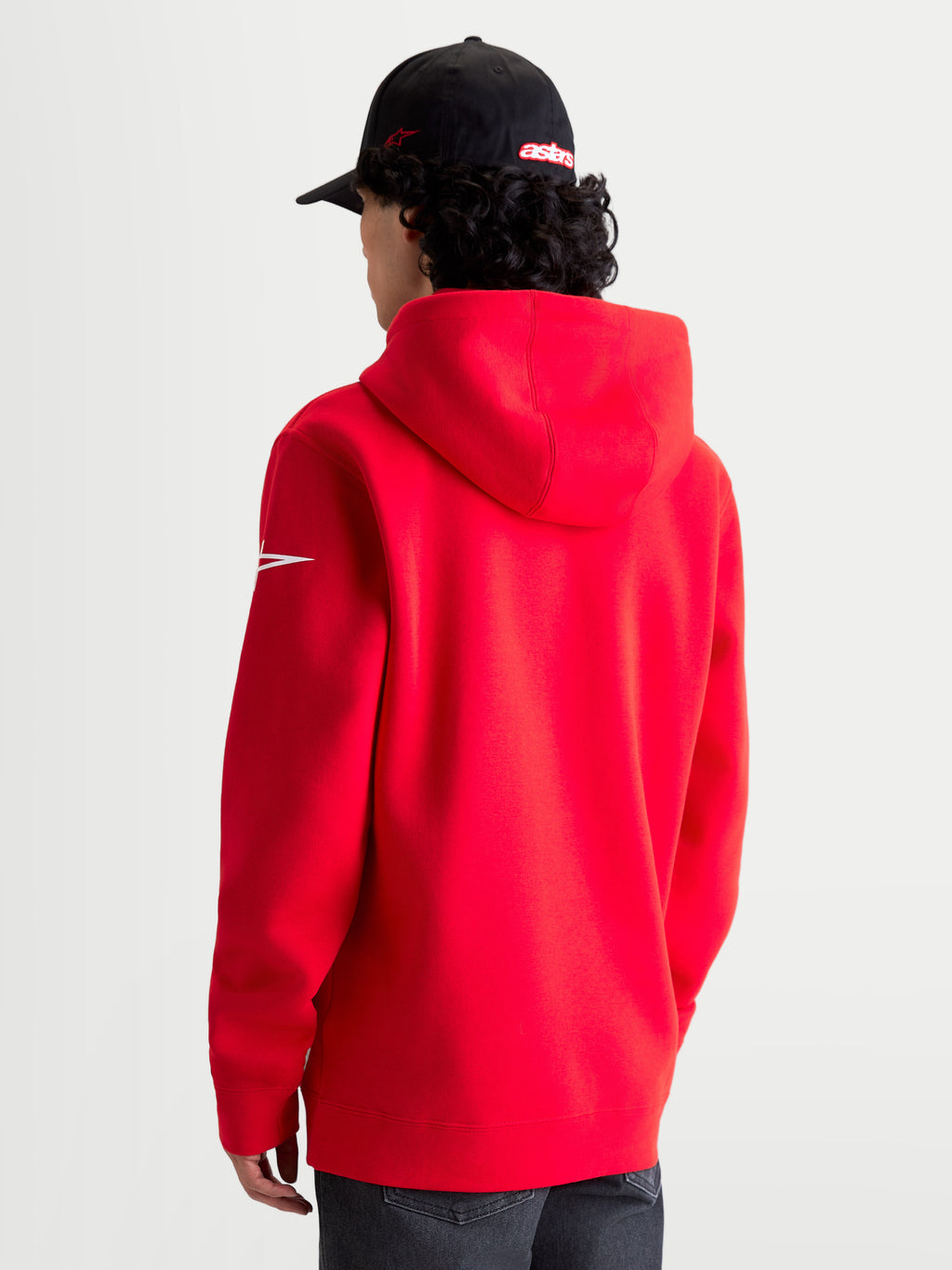 Alpinestars Race Wordmark Hoodie, Red and White Sportswear Pullover Fleece, rear view on model showing the hood and white Ageless sleeve logo, premium cotton and recycled polyester blend for a casual motorsport lifestyle.
