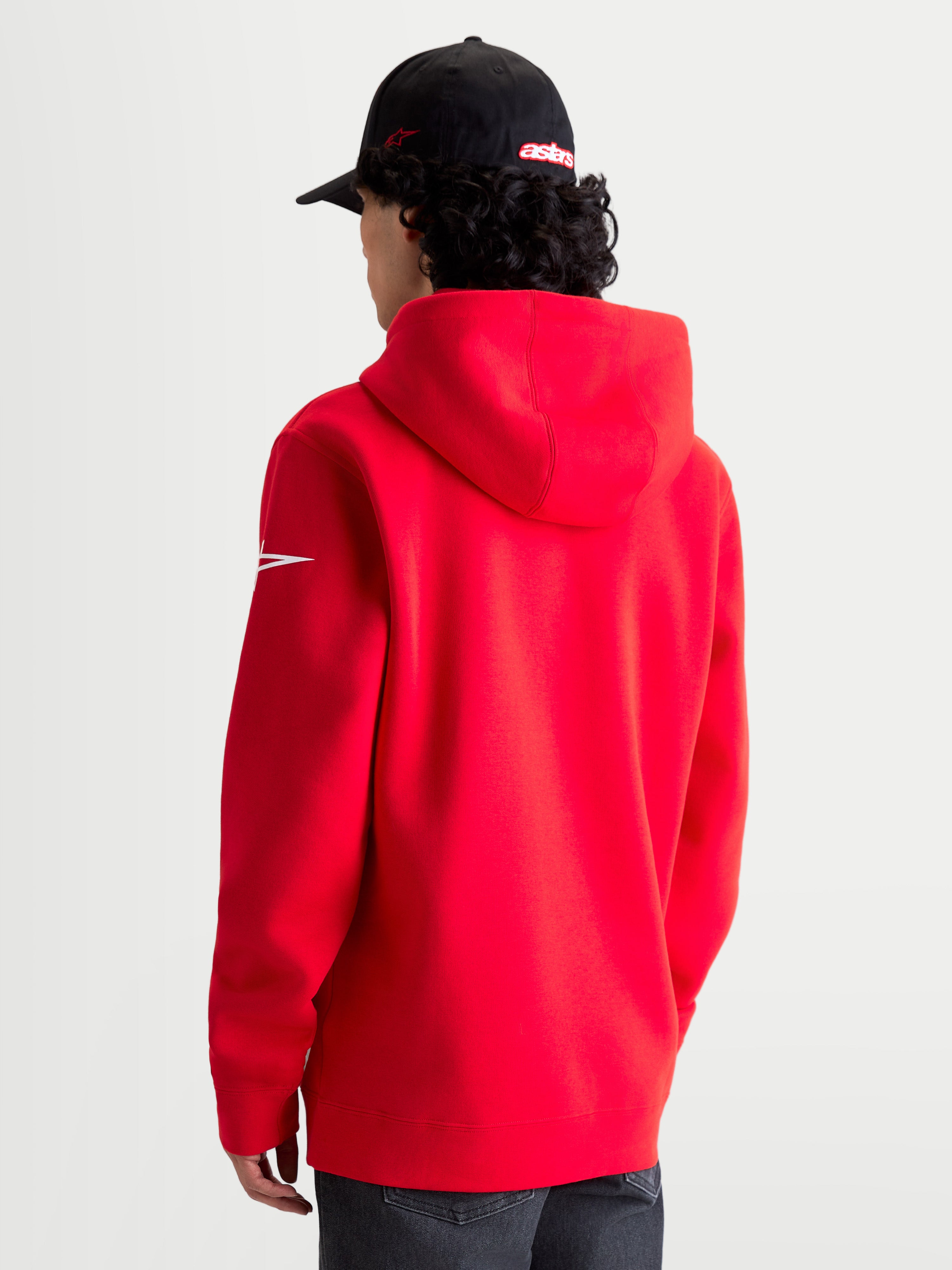 Alpinestars Race Wordmark Hoodie, Red and White Sportswear Pullover Fleece, rear view on model showing the hood and white Ageless sleeve logo, premium cotton and recycled polyester blend for a casual motorsport lifestyle.