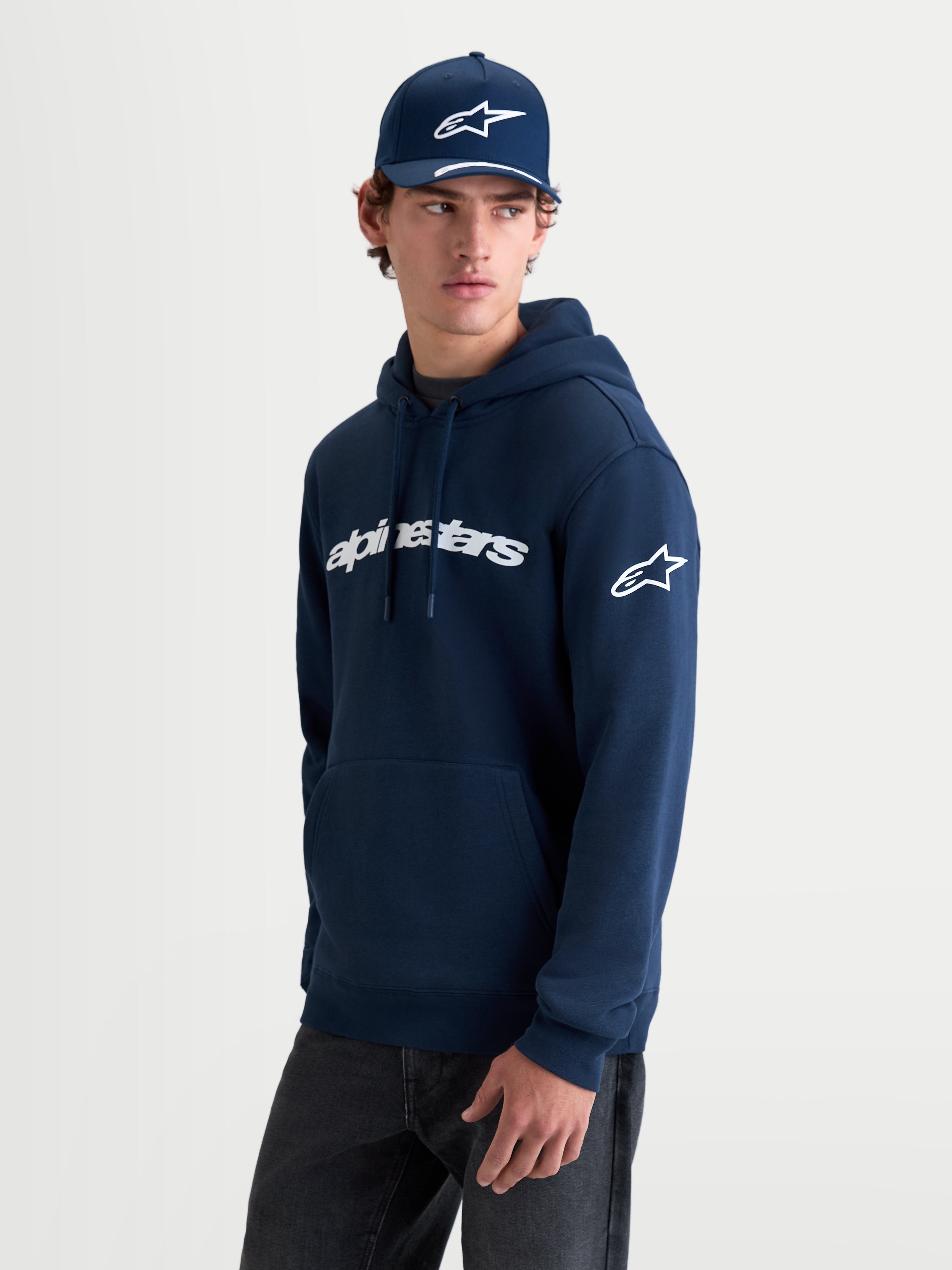 Alpinestars Race Wordmark Hoodie, Men's Sportswear Pullover Fleece, Navy Blue and White, featuring bold Alpinestars front wordmark and Ageless logo on the sleeve, 80% cotton and 20% recycled polyester construction, casual off-bike lifestyle apparel.