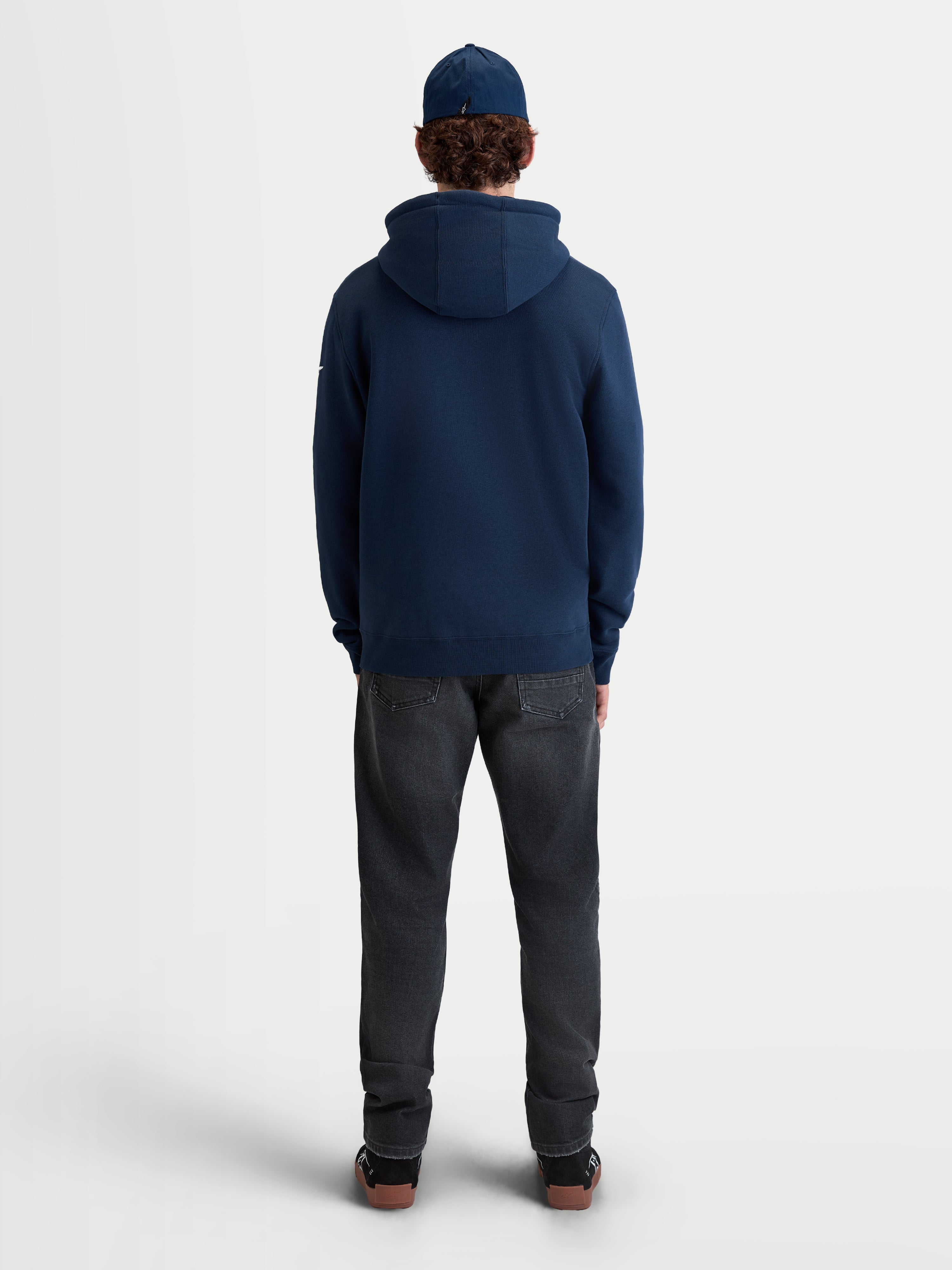 Alpinestars Race Wordmark Hoodie, Sportswear Pullover Fleece for casual everyday wear, rear view on model, Navy Blue, constructed from a soft cotton and recycled polyester blend with a self-lined hood and ribbed hem.