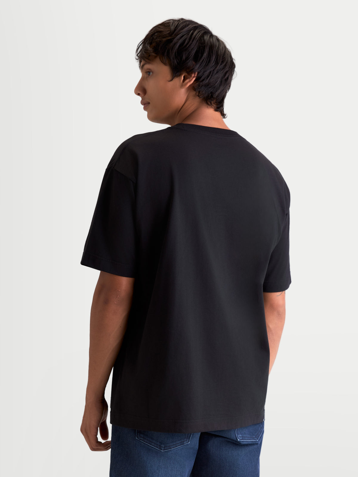 Alpinestars Chalk Oversized CSF Tee, Casual Sportswear Short Sleeve T-Shirt, Black, Back View on Model, Relaxed Fit with 60% Cotton and 40% Polyester blend construction.