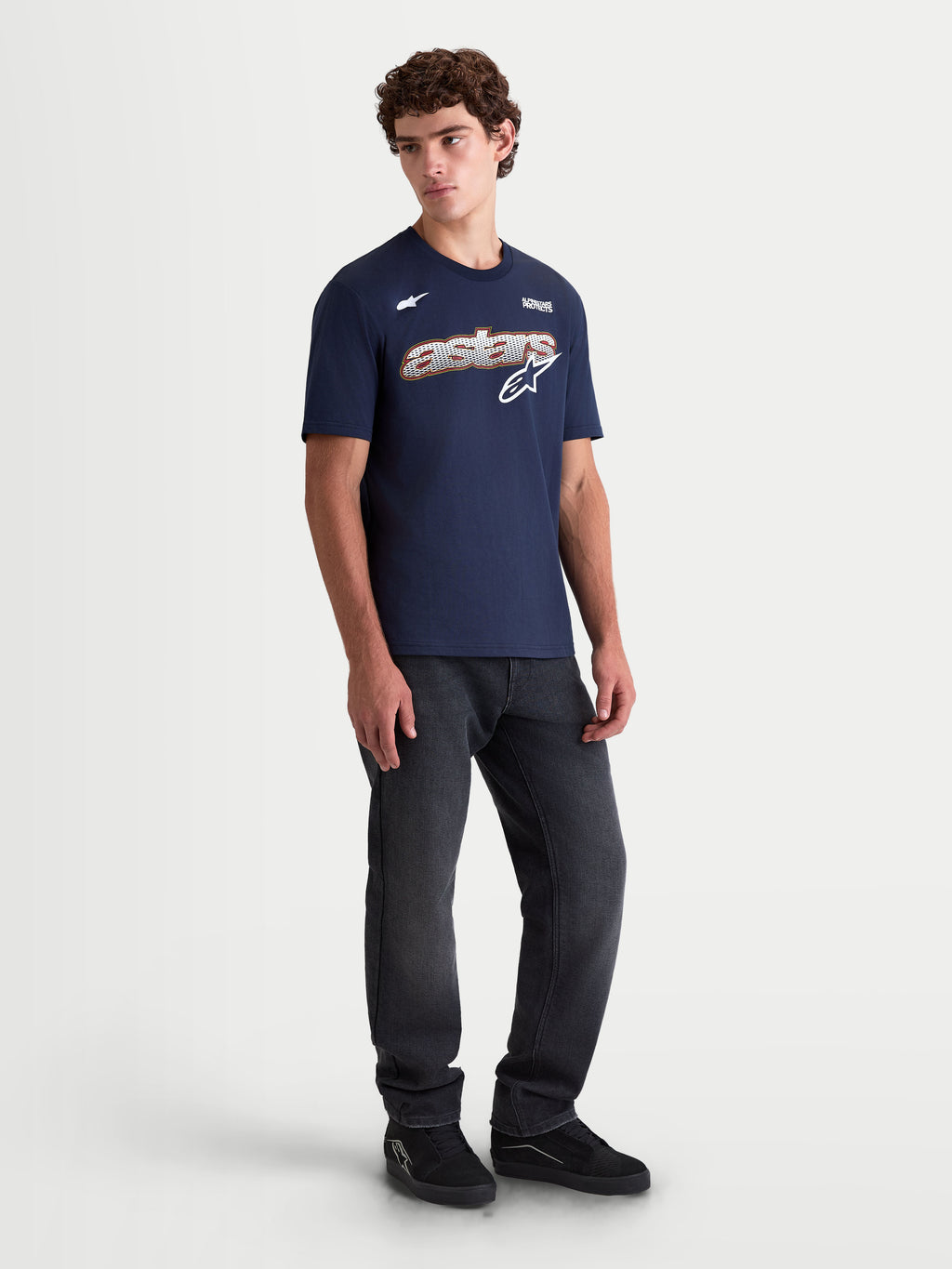 Alpinestars Cypress CSF Tee, Men's Short Sleeve Sportswear T-Shirt, Navy Blue, featuring a chest hit with a mesh-fill Astars word graphic and logo. Shown on a model for a casual look, this premium cotton-poly blend shirt is designed for daily comfort and motorsports lifestyle.