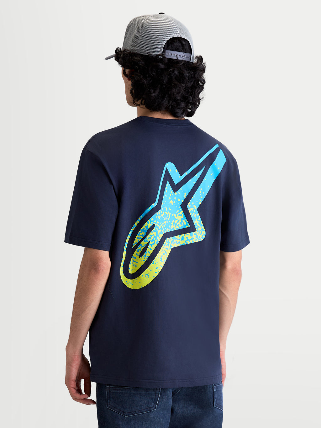 Alpinestars Meteor CSF Tee, Short Sleeve Sportswear T-shirt, Navy Blue, featuring a large Blue and Yellow gradient Astars logo on the back, on-model back view, casual motorsport-inspired apparel.