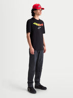 Alpinestars Elliptogrit CSF Tee, Men's Short Sleeve Sportswear T-Shirt, Black with Yellow and Red Gradient Graphic, featuring a curved Astars wordmark and soft-hand print, cotton-poly blend for everyday comfort, on-model view.