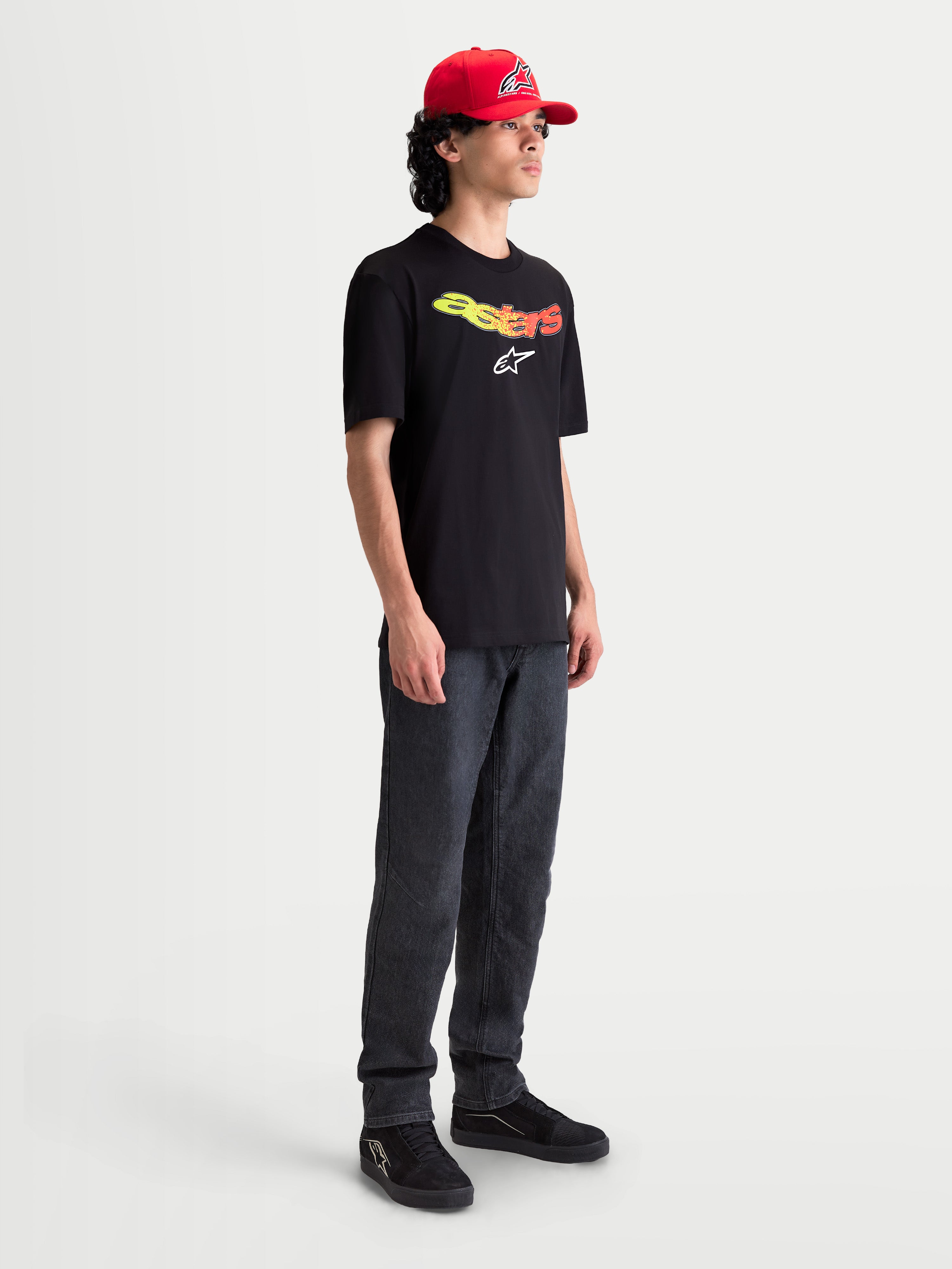 Alpinestars Elliptogrit CSF Tee, Men's Short Sleeve Sportswear T-Shirt, Black with Yellow and Red Gradient Graphic, featuring a curved Astars wordmark and soft-hand print, cotton-poly blend for everyday comfort, on-model view.