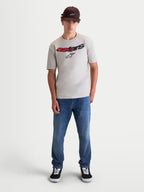 Alpinestars Elliptogrit CSF Tee, Men's Short Sleeve Sportswear T-shirt, Cement Gray, featuring a front graphic with a curved Astars wordmark and red-to-black gradient detailing. This soft-hand print cotton-poly blend tee is designed for casual everyday wear and motorsport-inspired lifestyle, shown on model.