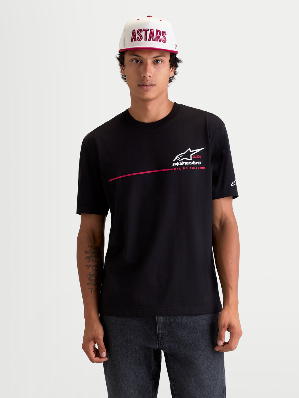 Alpinestars P1 CSF Tee, Men's Short Sleeve Sportswear T-Shirt, Black with White and Red Race Stripe Logo Graphic, 60/40 Cotton-Poly Blend, Casual Motorsport Lifestyle Apparel worn by model.