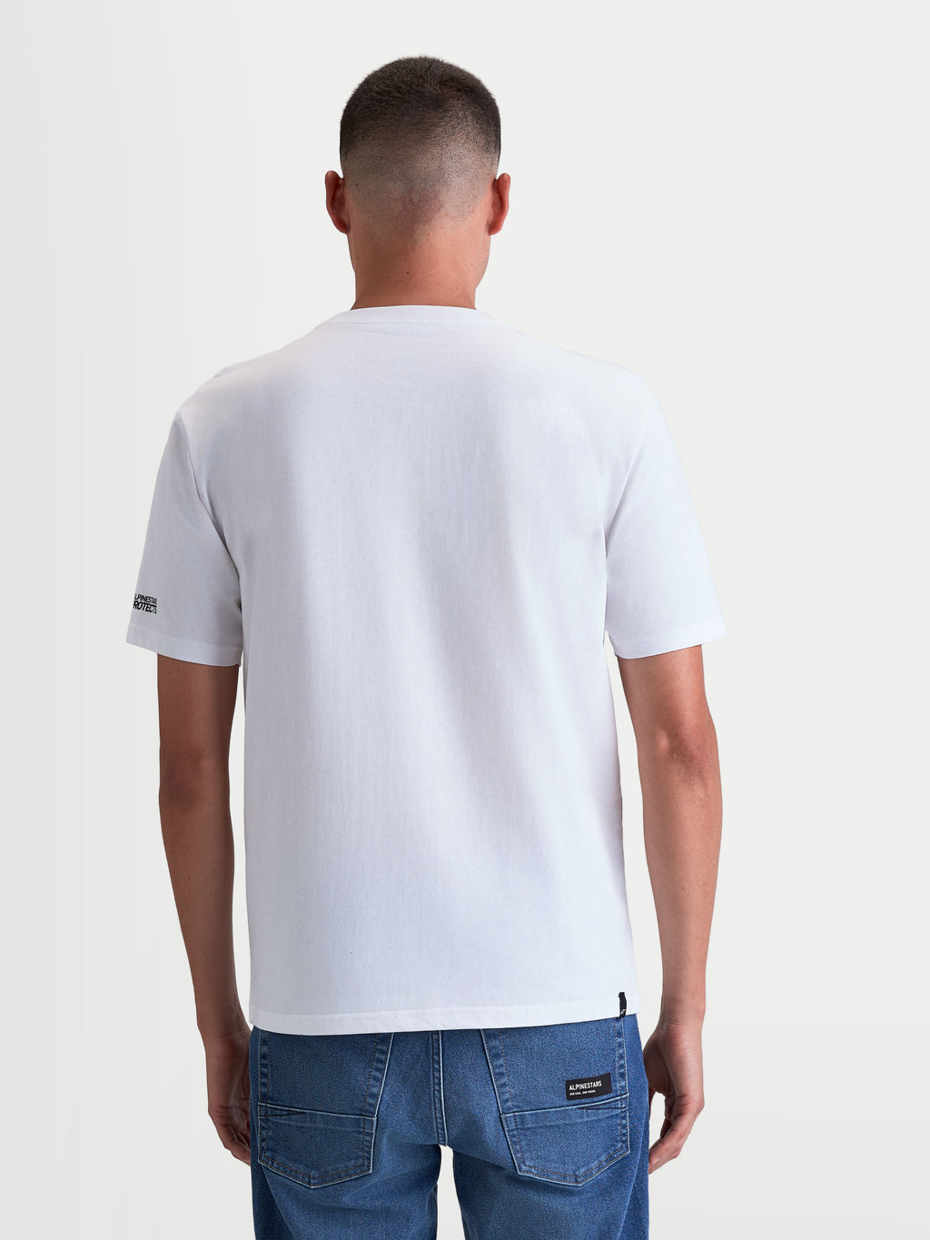 Alpinestars P1 CSF Tee, Short Sleeve Sportswear T-Shirt, Unisex, White, Back View on Model, Cotton-Polyester Blend, featuring Alpinestars Protects logo on the sleeve.