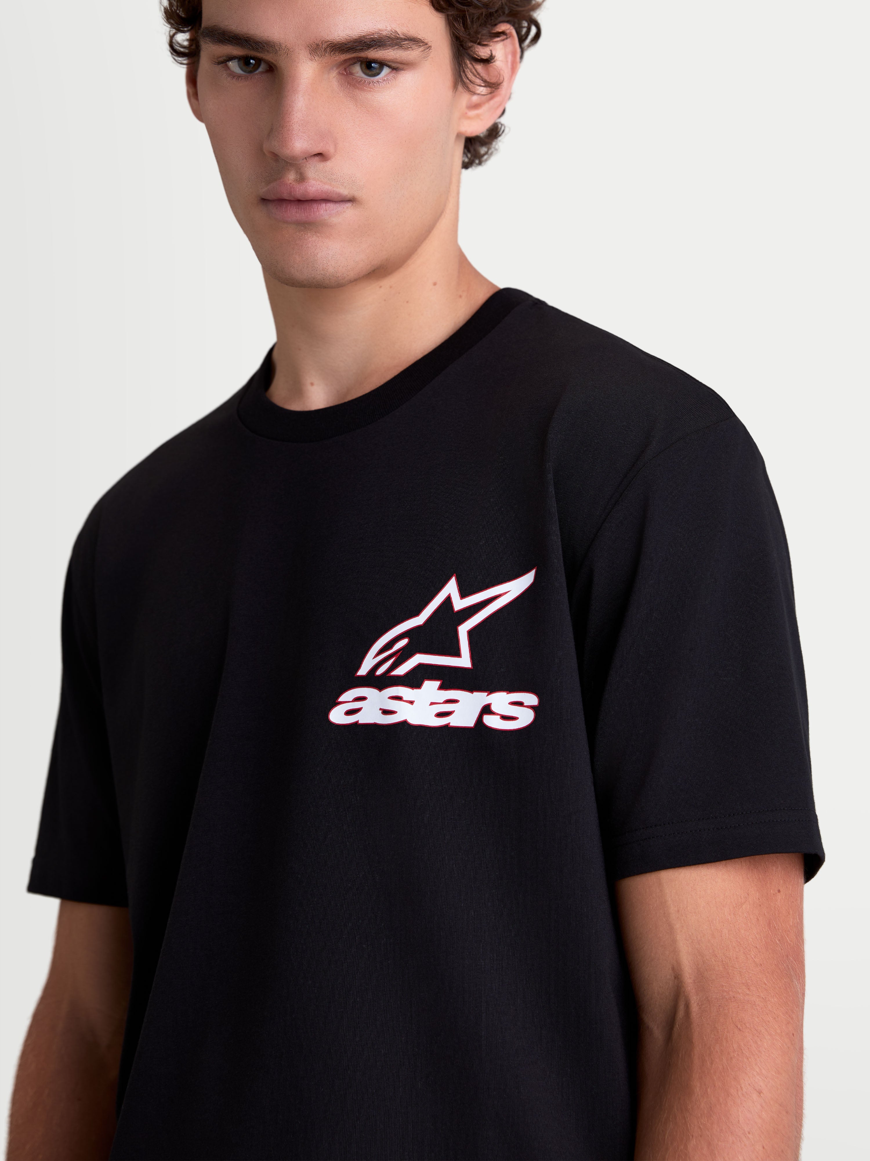 Alpinestars Lineout CSF Tee, Short Sleeve Sportswear T-Shirt on model, Black with White and Red Astars Logo Graphic, Cotton-Poly Blend, Casual Lifestyle Wear for Men and Women