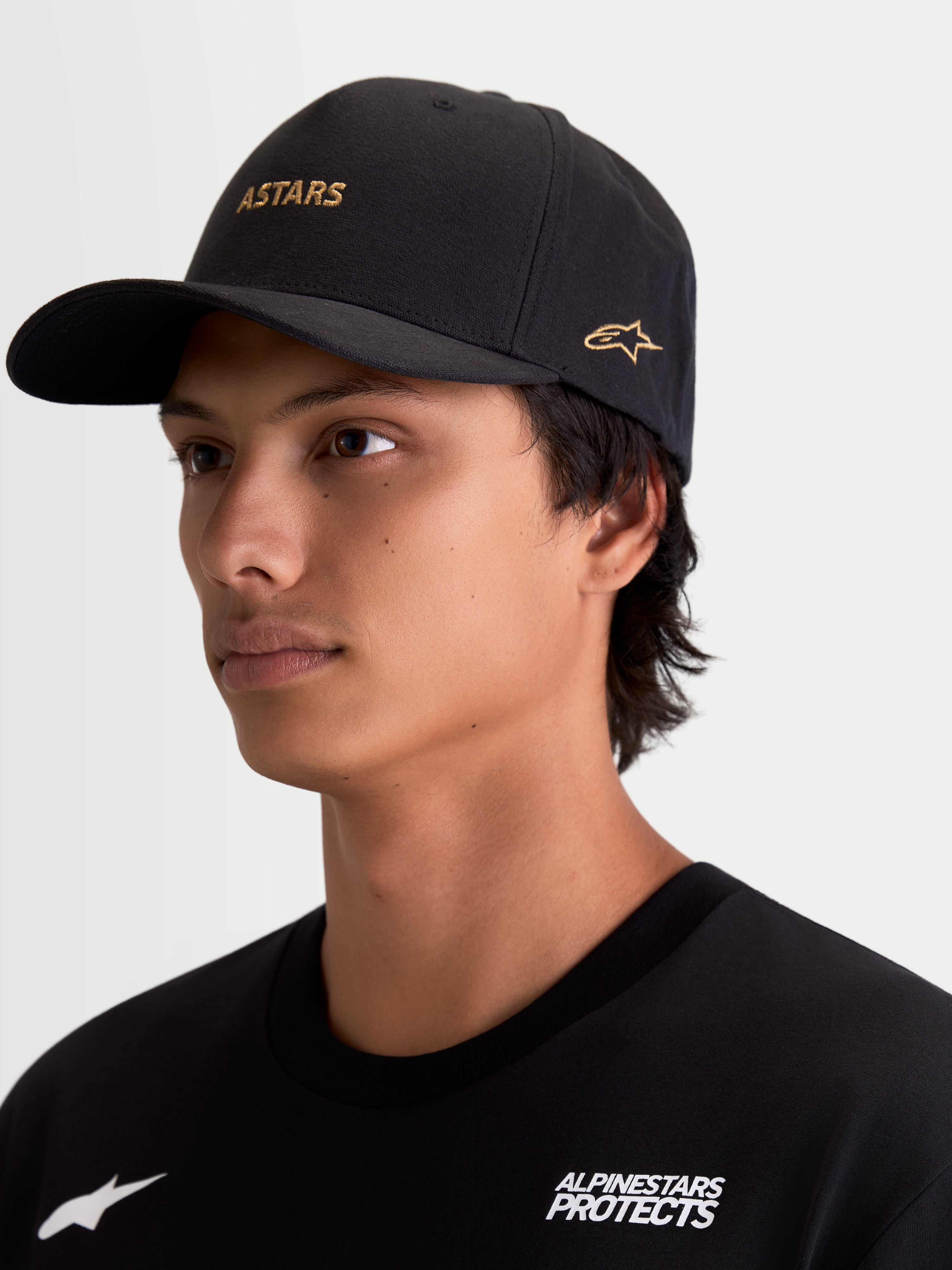 Alpinestars County Canvas Hat, Black Sportswear Cap featuring Gold ASTARS Word Logo and Side Logo Embroidery, Curved Bill and Structured Crown, Oxford Peached Canvas Fabric, Motorsport-Inspired Everyday Lifestyle Wear.