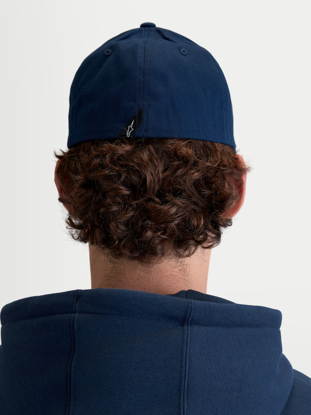 Alpinestars Arclight Hat, Unisex Sportswear Baseball Cap, Navy Blue, Durable Cotton Twill with Flex Back, Rear View on Model showing signature Astars logo label detail.