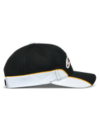 Alpinestars 500 Snapback Hat, Motorsport-inspired Sportswear Baseball Cap, Black and White with orange trim, side profile showing curved bill, structured crown, and contrast piping detail.