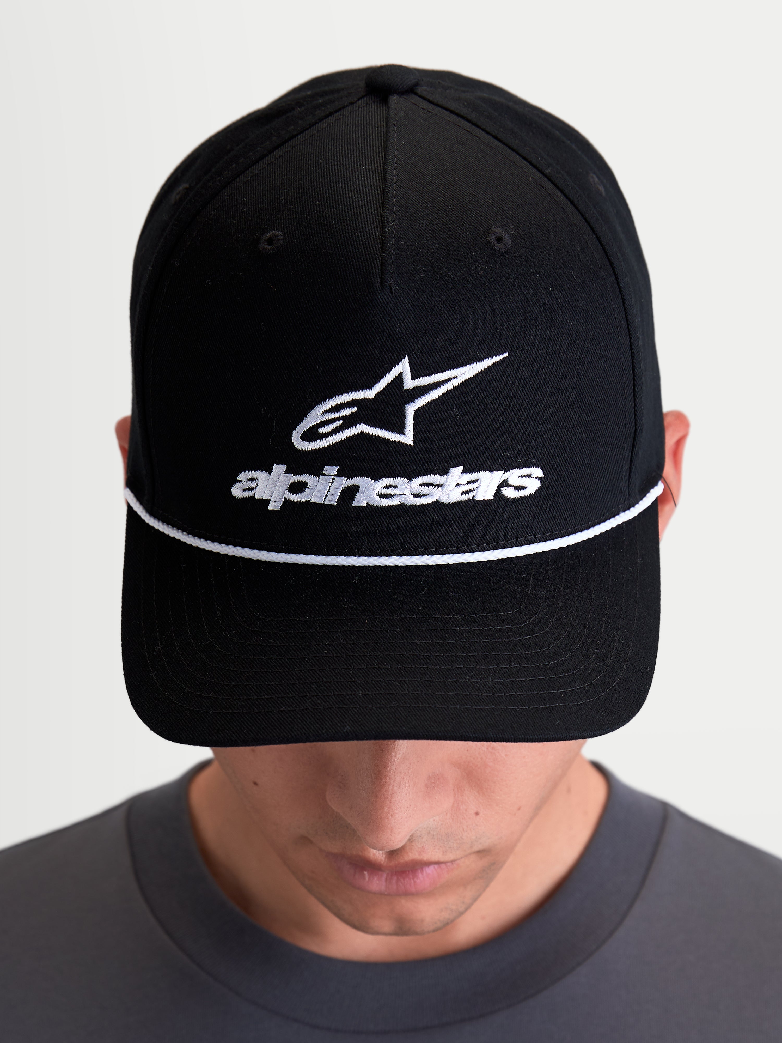 Alpinestars Combo Logo Snapback Hat, Casual Sportswear Cap, Unisex, Black and White, featuring a structured crown, curved bill with white decorative rope, and front Astars logo embroidery, premium cotton twill construction.