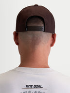 Alpinestars Combo Logo Snapback Hat, Casual Motorsport Sportswear Cap for Men and Women, Brown, Durable Twill Construction, Rear View on Model showing Adjustable Snapback Closure and Branded Label.