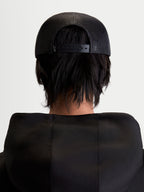 Alpinestars Gravel Trucker Hat, Sportswear Snapback Cap, Unisex, Black, Rear View on Model showing the Breathable Poly Mesh Back and Adjustable Snapback Closure.