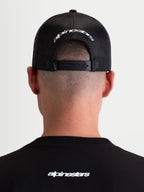 Alpinestars Meteorite Trucker Hat, Casual Sportswear Mesh Back Cap, Black and White, featuring an adjustable snapback closure and white embroidered Alpinestars logo on the rear.