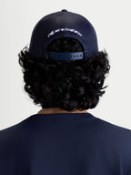 Alpinestars Meteorite Trucker Hat, Sportswear Casual Headwear, Rear View on Model, Navy Blue, Poly Mesh Back and Adjustable Snapback Closure with White Embroidered Branding