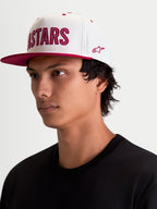 Alpinestars Stadium Snapback Hat, Sportswear Lifestyle Cap, Off White and Red, featuring a flat bill, structured crown, and front Astars logo applique with contrast running stitch and side embroidery, on-model view.
