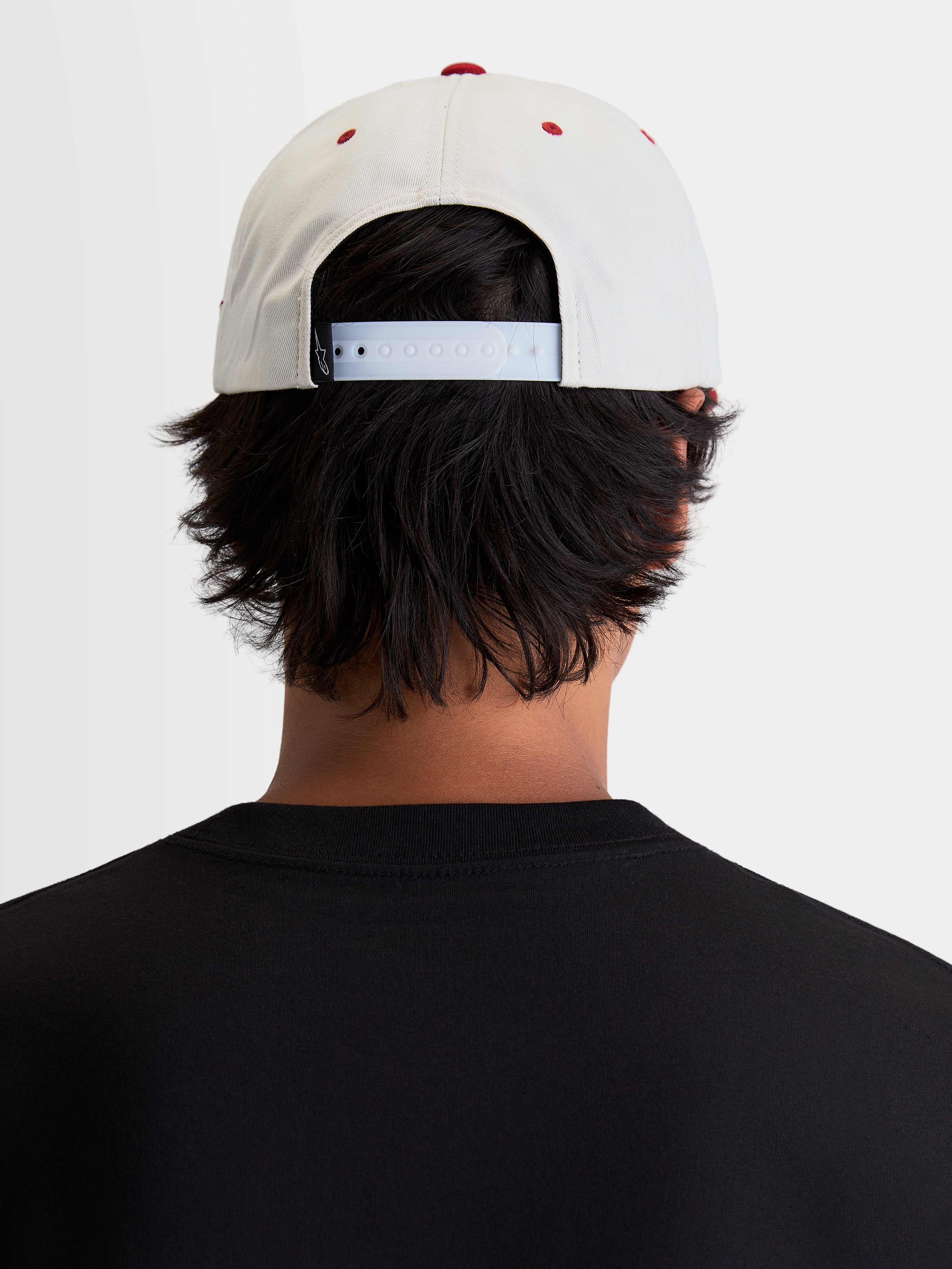 Alpinestars Stadium Snapback Hat, Sportswear Casual Cap, Off White and Red, featuring an adjustable snapback closure and structured crown, back view on-model showing the fit for everyday motorsport-inspired lifestyle.