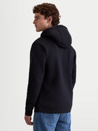 Alpinestars Ageless V3 Hoodie, Men's Sportswear Pullover Fleece, Black, soft cotton and recycled polyester blend, back view showing hooded design and ribbed cuffs, comfortable lifestyle apparel for motorsports enthusiasts.