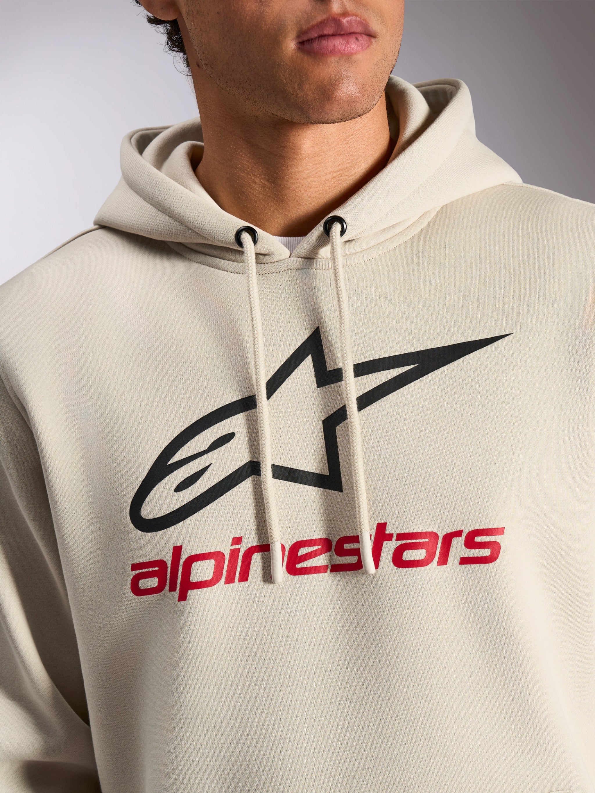 Alpinestars Always V3 Hoodie, casual streetwear, off-white with black star logo and red Alpinestars text, drawstring hood, premium fleece, modern motorsport-inspired design