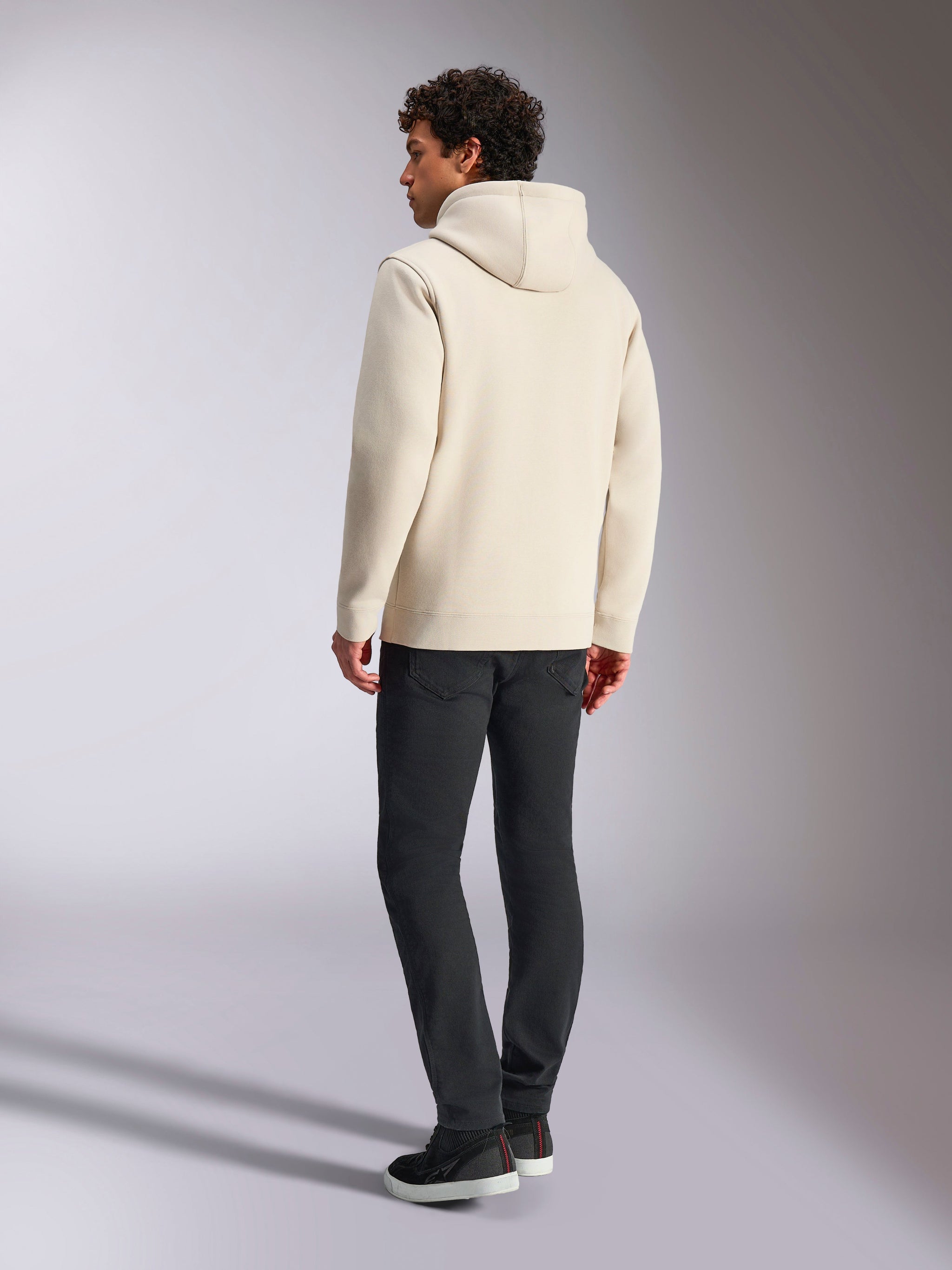 Alpinestars Always V3 Hoodie, Off White, back view of male model wearing the hoodie and black pants, casual motorsport-inspired streetwear, minimalist design with hood and ribbed hem