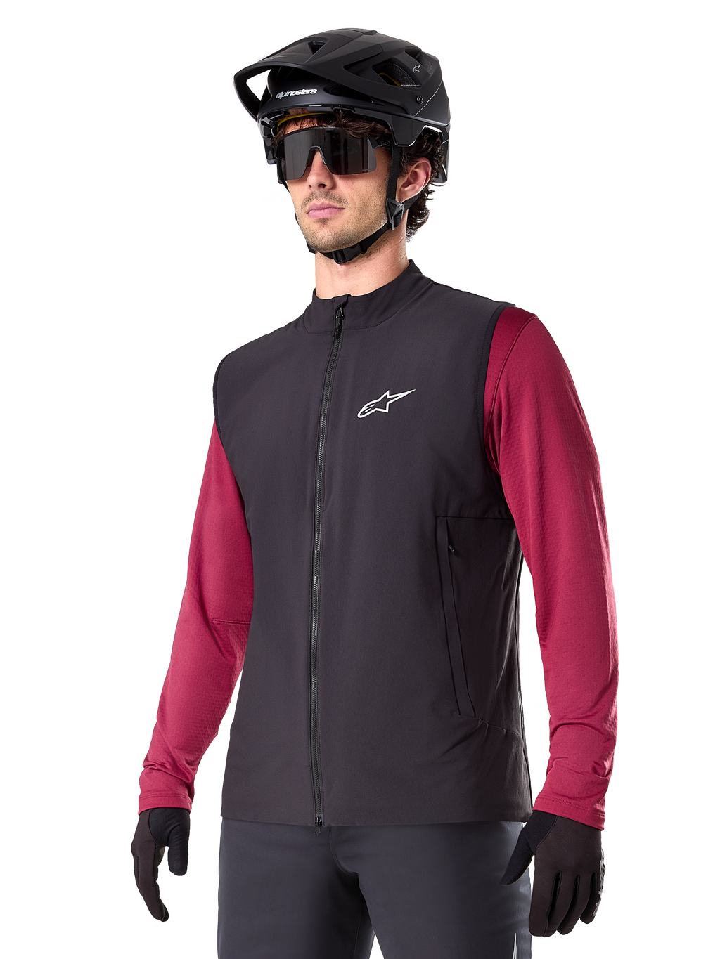 Alpinestars A-Dura Thermal Vest, Black, Cycling Thermal Gilet, worn over a maroon long-sleeve shirt, featuring a white chest logo, paired with a black MTB helmet and sunglasses, insulated performance layer for mountain biking