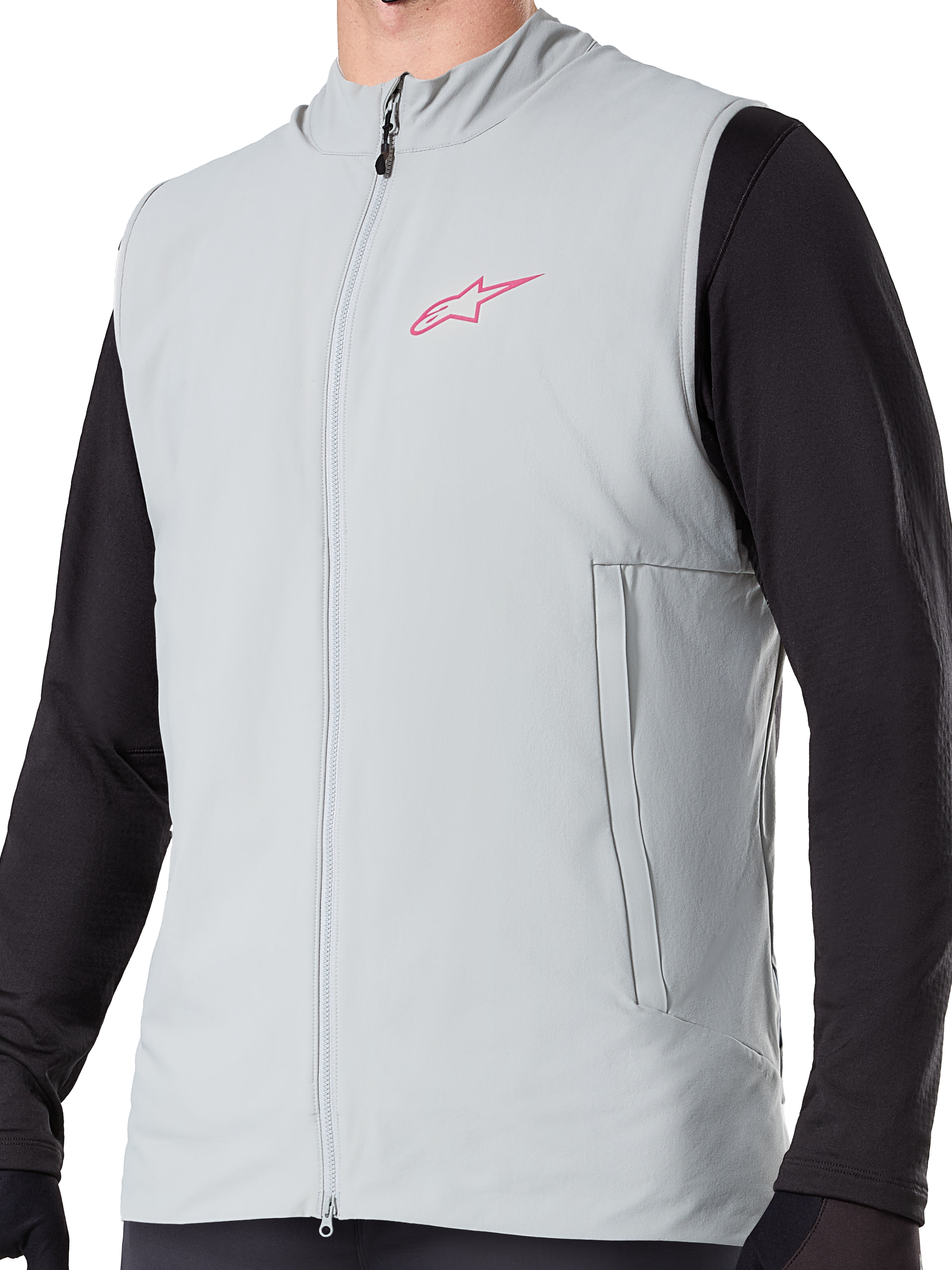 Alpinestars A-Dura Thermal Vest, Titanium Gray insulated cycling gilet, featuring a pink star logo on the chest, worn over a black long-sleeve top, includes a vertical zippered pocket and full front zip, designed for cold-weather mountain bike trail riding.