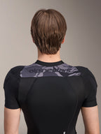 Alpinestars A-Motion Plasma Protection Jacket - Short Sleeve, Back view of upper torso, Black with Grey Camo panel across shoulders featuring Alpinestars logo, breathable stretch mesh construction for MTB protection