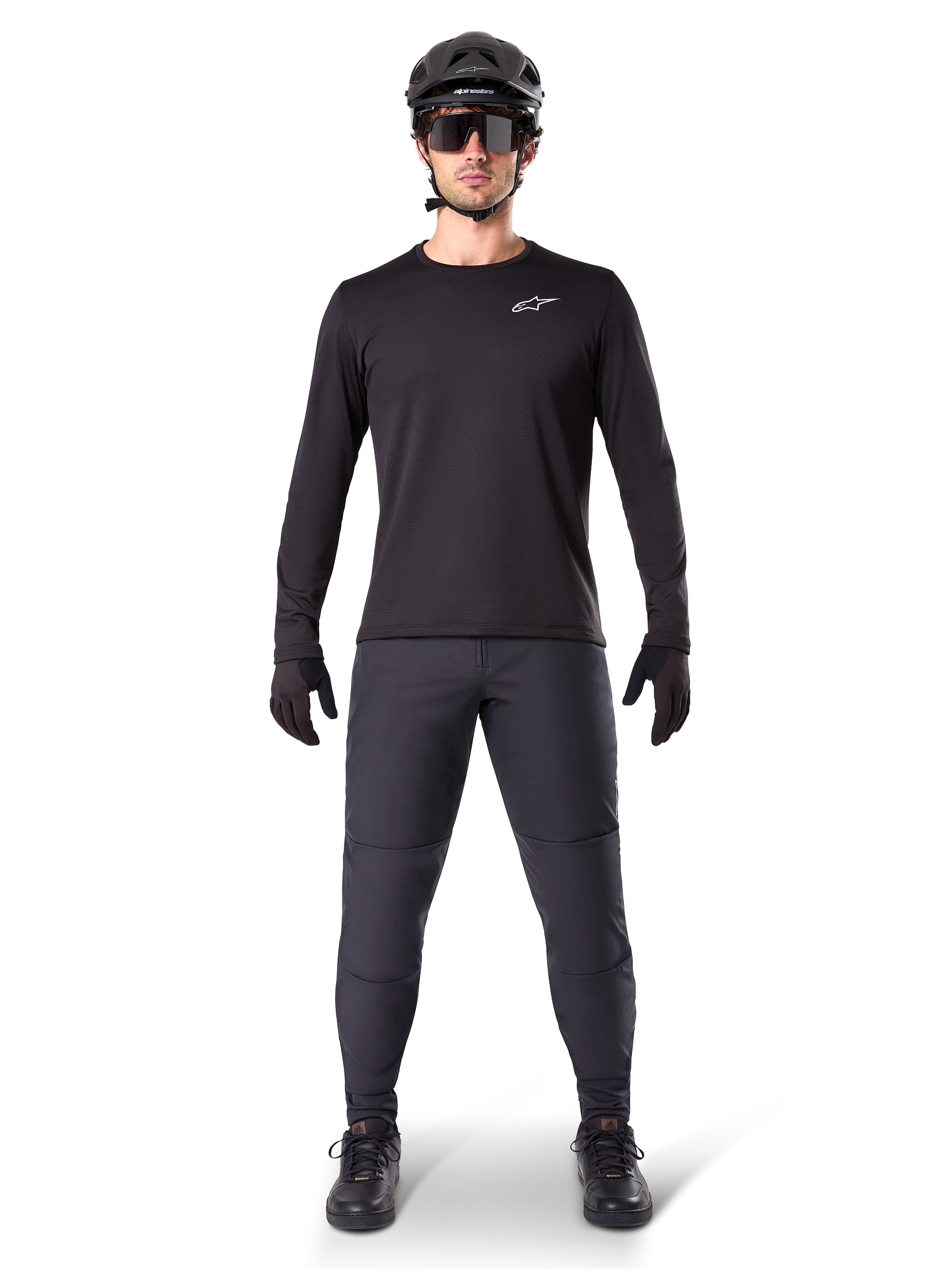 Alpinestars A-Dura Thermal Pant, Black, worn by a rider in complete mountain bike gear including a black long-sleeve jersey, helmet, and sunglasses, durable pants with a regular fit for cold-weather trail riding