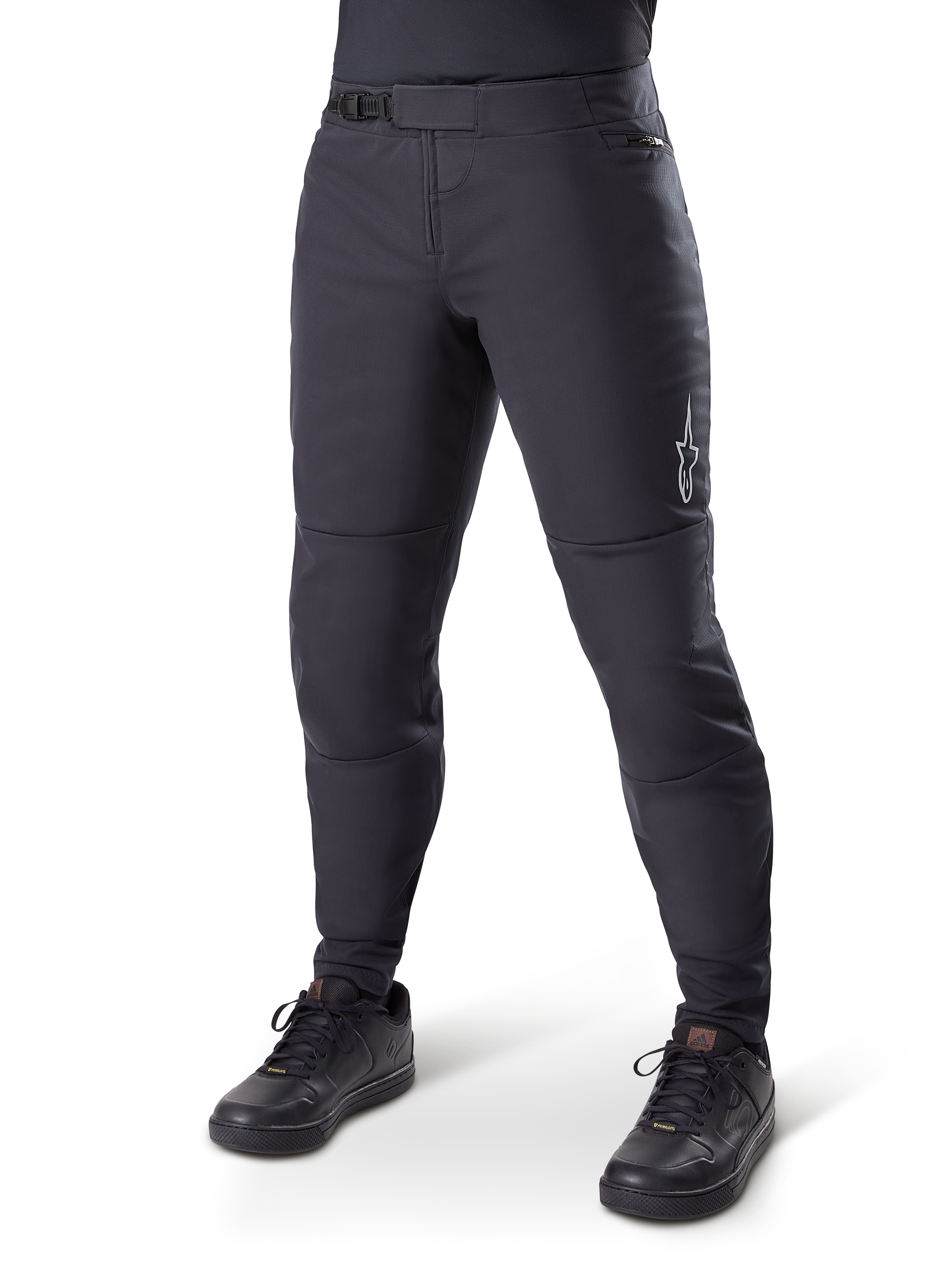 Alpinestars A-Dura Thermal Pant, Black Mountain Bike Pants, worn with black cycling shoes, featuring a ratchet waist closure, small white logo on the thigh, tapered fit for cold-weather riding