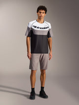Gray A-Dura Ride Shorts on model, paired with an Alpinestars jersey for durable, performance mountain bike gear.