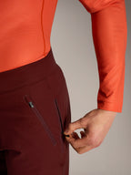 Alpinestars A-Dura Ride Shorts in bordeaux, detail of a hand opening the secure zippered mesh-lined side pocket.