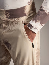 Alpinestars A-Dura Ride Shorts in Sand Camo, showing a zippered side pocket and durable 4-way stretch MTB fabric.